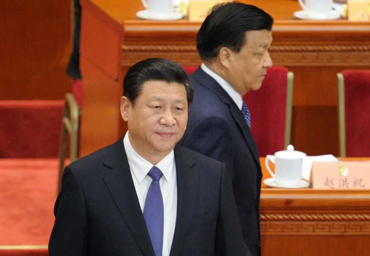 Liu Yunshan (top), a member of the Standing Committee of the Political Bureau of the Communist Party of China (CPC) Central Committee, walks past Chinese president Xi Jinping as they arrive at the opening session of the Chinese People's Political Consultative Conference (CPPCC) at the Great Hall of the People in Beijing on March 3, 2014. (WANG ZHAO/AFP/Getty Images)